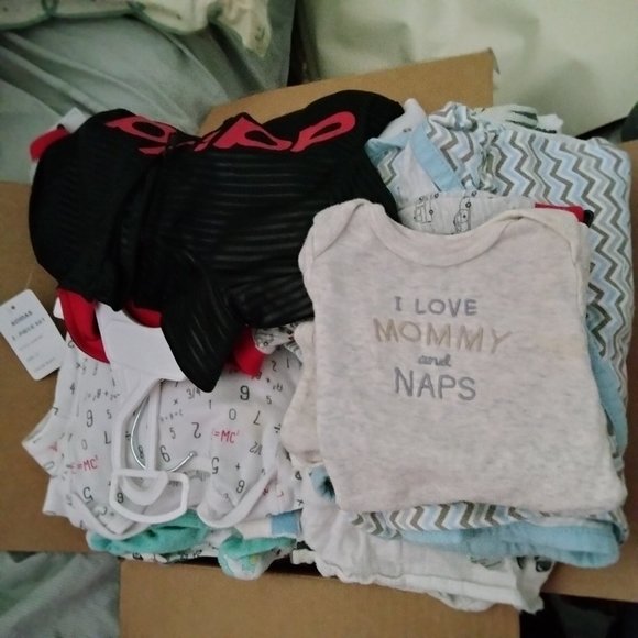 New boxes of boys cloths , diapers , bottles ,